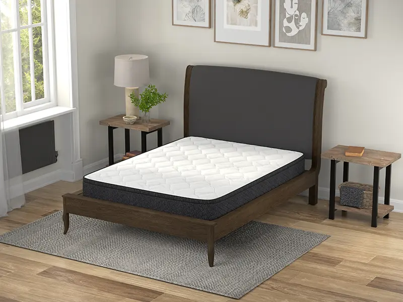 American Bedding 9" Medium Euro innerspring mattress on a wooden bed frame, featuring a Euro top, set in a cozy bedroom with natural light, showcasing comfort and support for various sleepers.