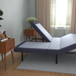 Adjustable mattress base in a modern bedroom setting, showcasing a raised head position, surrounded by a nightstand and indoor plants, emphasizing customized sleep solutions.