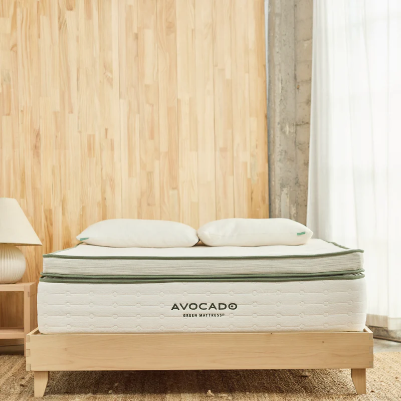 Avocado Green Double BoxTop mattress with plush top and natural materials, set in a bright bedroom with wooden walls and soft lighting.